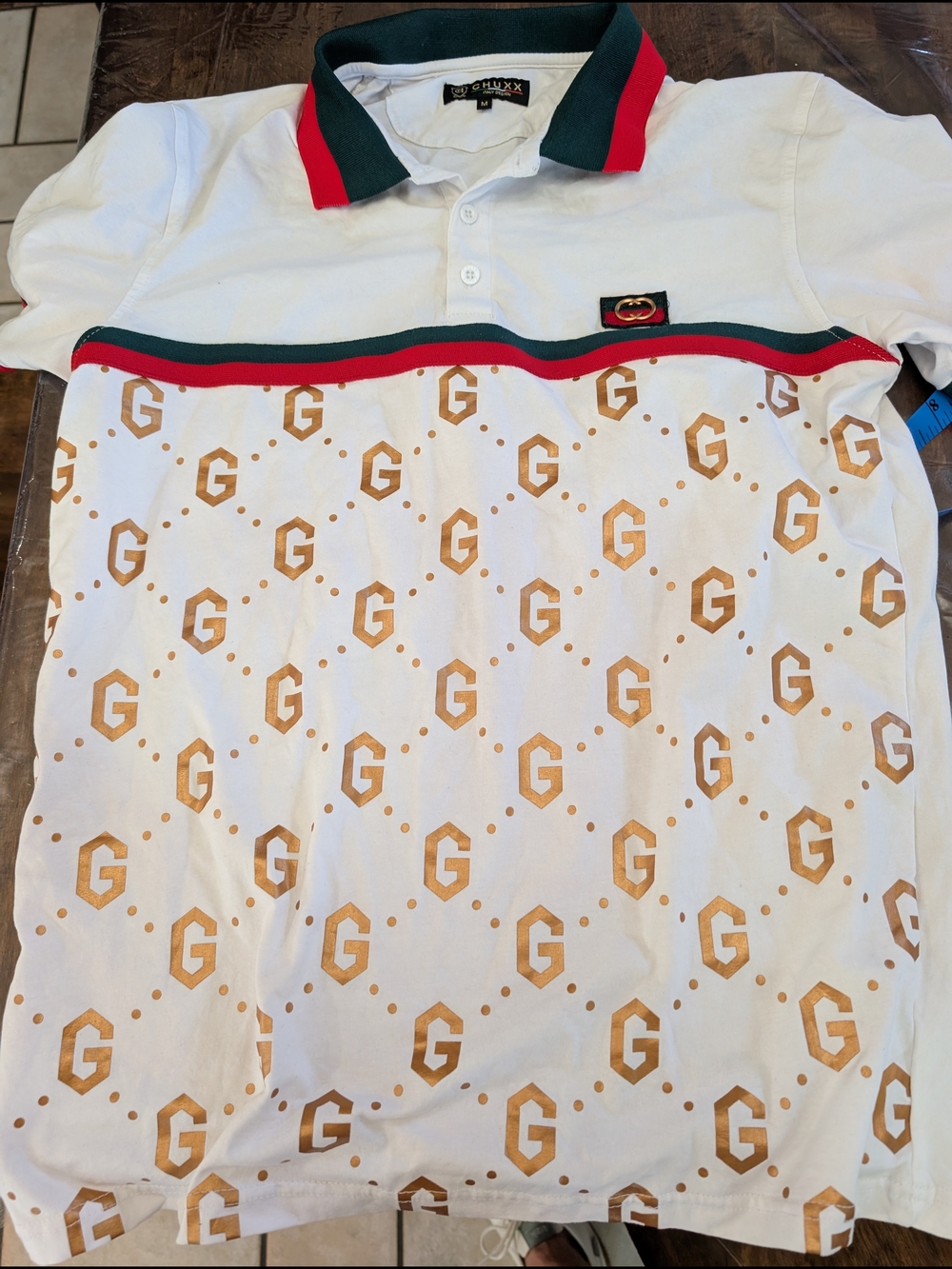 Chuxx White Polo Shirt with Tan G Print and Green-Red Trim